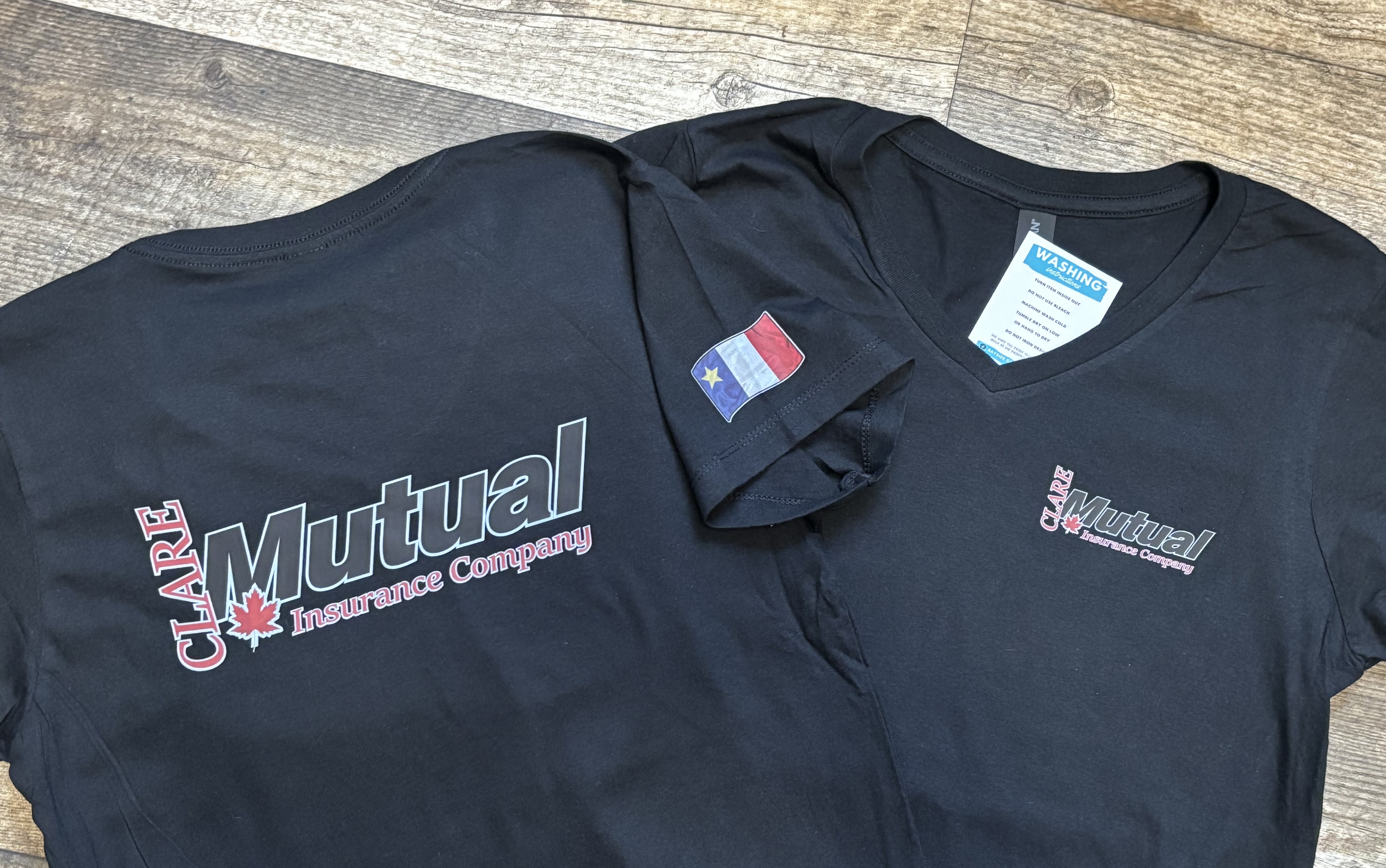 Clare Mutual Insurance Company custom t-shirts with Acadian flag
