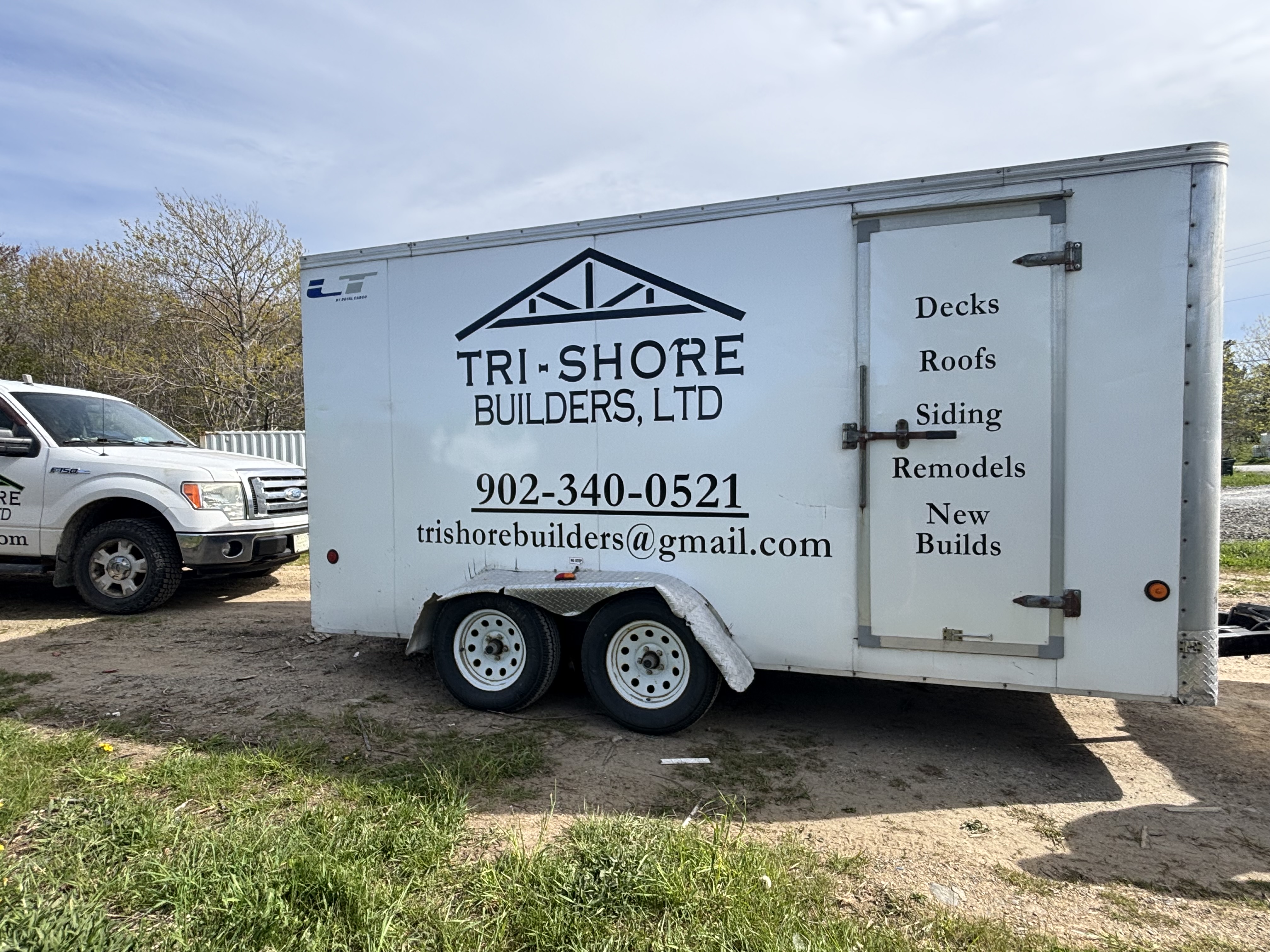 Tri-Shore Builders Ltd trailer — side with services list